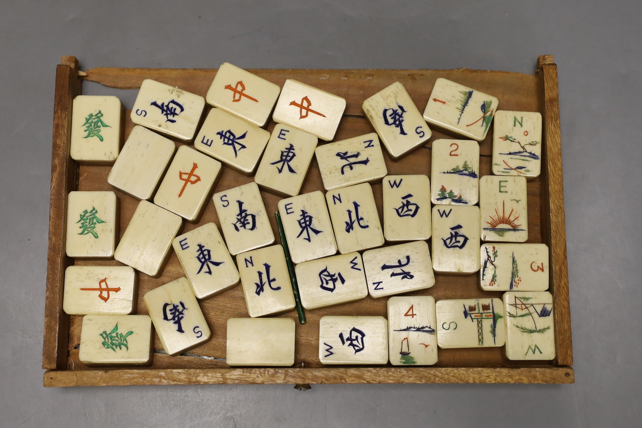 A Chinese bamboo and and bone mahjong set, 18 cms high x 25ms wide.